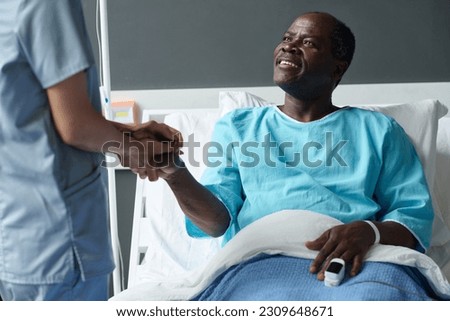 Elderly patient talking to nurse in ward Royalty-Free Stock Photo #2309648671