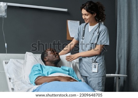 Nurse caring about patient in ward