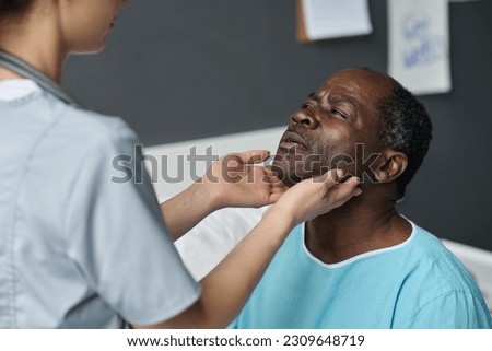 Nurse examining throat of patient