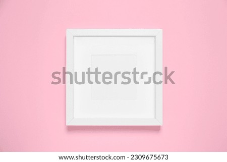 Empty photo frame on pink background, top view. Space for design