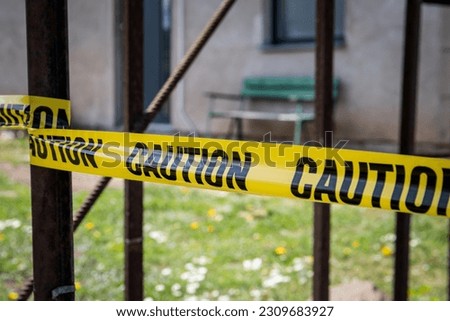 CAUTION tape. Metal constructions. Hazard, construction or waste.
