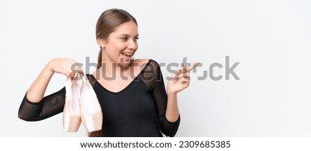 Young beautiful blonde woman practicing ballet isolated on white background pointing finger to the side and presenting a product