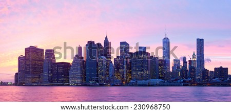 New York City, USA. Downtown buildings in Manhattan with colorful lights, panorama at sunset  