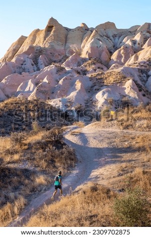 Person running at Rose valley, Cappadocia, Turkey. Vertical picture