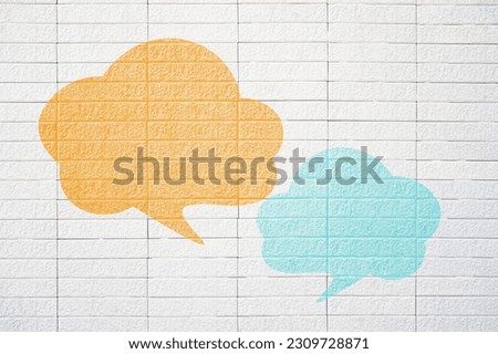 Conceptual image about communication and social media, customer feedback, Blank couple speech bubble, orange  and blue on grunge white brick wall              
