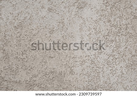 Old wall of a house with pastel colors and a spatula pattern