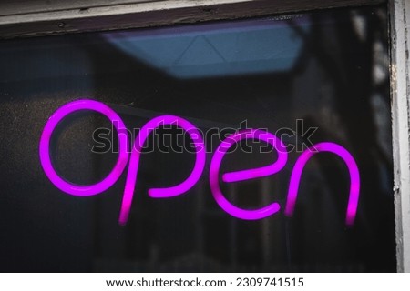 Open sign in the window of a shop on a scnadinavian street