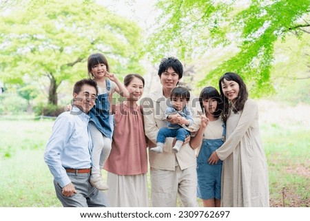 A three-generation family living happily with smiles on their faces
