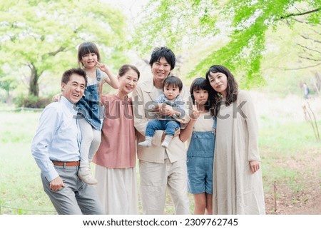 A three-generation family living happily with smiles on their faces