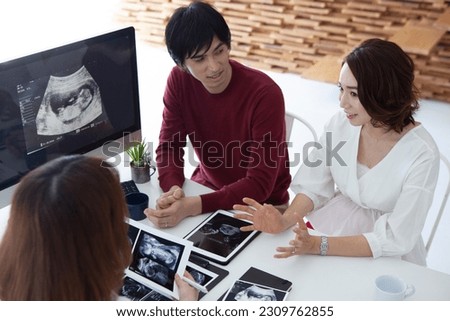 Young pregnant couple listening to an obstetrician-gynecologist
