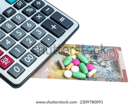 Kuwait dinar and pills with calculator isolated on white background. Medicine cost in Kuwait city.