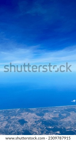 Beautiful landscape of fields with a bird`s-eye view. Wing Through Plane passenger Window. Panoramic view.