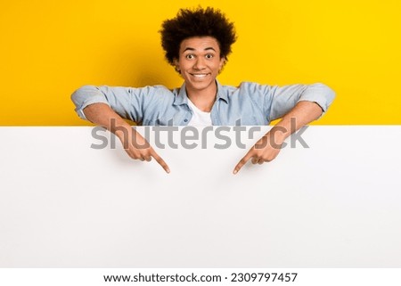 Photo of positive person indicate fingers down empty space novelty isolated on yellow color background