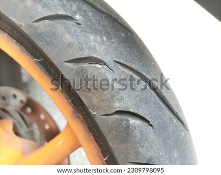 small cracks in motorcycle tires that have been used for a long time. risk of tire blowout. not safe Royalty-Free Stock Photo #2309798095
