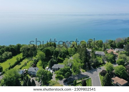 Experience the breathtaking lakeside view of this luxury house, yacht marina, panoramic scenery, and the beauty of city parks. Captured with stunning drone photography, immerse yourself in luxury life Royalty-Free Stock Photo #2309802541
