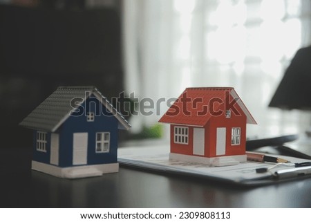 Female woman hands holding home model, small miniature white toy house. Mortgage property insurance dream moving home and real estate concept