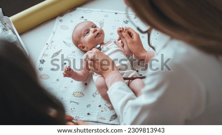 Doctor pediatrician and baby patient. Medical checkup. Doctor pediatrician examining little baby with stethoscope in clinic. Female doctor listens to the heart with stethoscope 