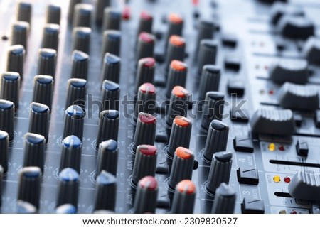 Colorful knobs and switches of audio mixer or recording console. Recording background.  shallow depth of field.