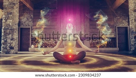 Beautiful Relaxed Caucasian Woman In Lotus Position Meditating In Zenlike Openair Space. Edited Visualization Of Multi Colored Chakras Glowing On Her Body. Spirituality, Yoga, Mindfulness Concept. Royalty-Free Stock Photo #2309834237