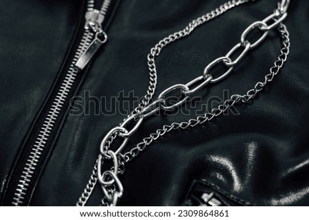 Chain on black texture eco soft leather, fashionable jacket. Royalty-Free Stock Photo #2309864861