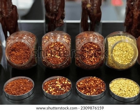 Pictures of different types of chilies dried and processed into various types of chilies beautifully packaged in glass bottles.