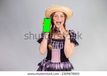 Blonde Brazilian woman, June party clothes, arraial. smartphone, green screen.