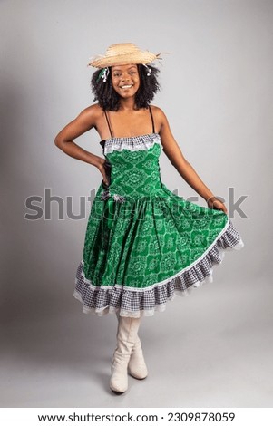 vertical portrait, black Brazilian woman in festa junina clothes. Saint John's festival.