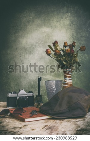 classic still life  with Roses wither and notebook  old film vintage style