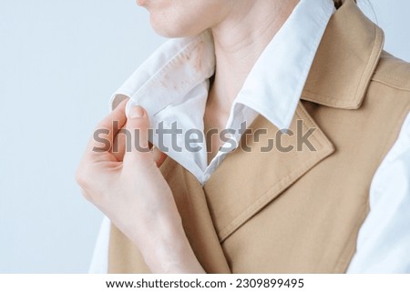 Hand showing dirty sweat and cosmetic stain. Soiled clothes. Liquid foundation stains. daily life stain concept. High quality photo