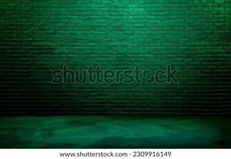 lighting effect gree on empty brick wall background for design. dark black brick wall background, rough concrete, plastered concrete floor, with green glowing lights from above. Royalty-Free Stock Photo #2309916149
