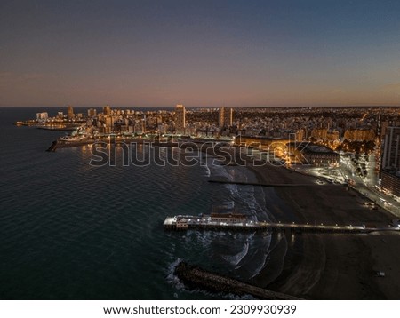 Sunset over Mar del Plata city in Buenos Aires Argentina. City skyline and beach on sunset and at night. Aerial drone shot Royalty-Free Stock Photo #2309930939