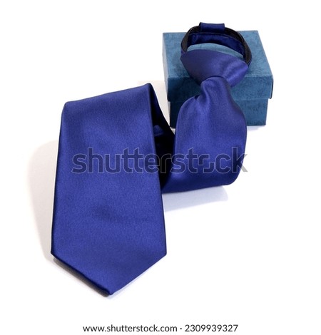 plain blue colour polyester fabric necktie folded isolated over white background with gift box close up shot, single object, business concept, items for sale template  Royalty-Free Stock Photo #2309939327