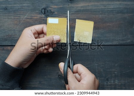 Photo illustration of a woman cutting up her credit card because she doesn't want to use it anymore                        