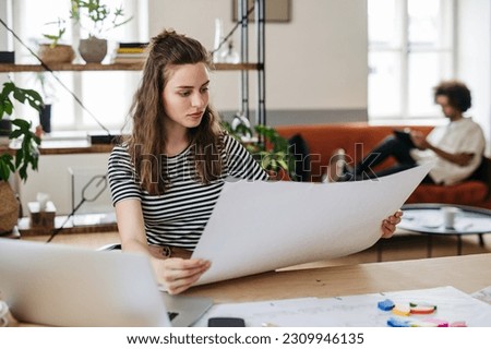 Young woman working in startup office business.