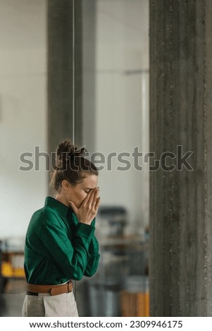 Young sad woman in office, having problem. Royalty-Free Stock Photo #2309946175