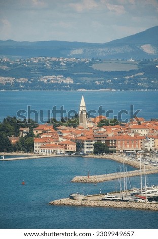 Old small coastal town with church tower Royalty-Free Stock Photo #2309949657