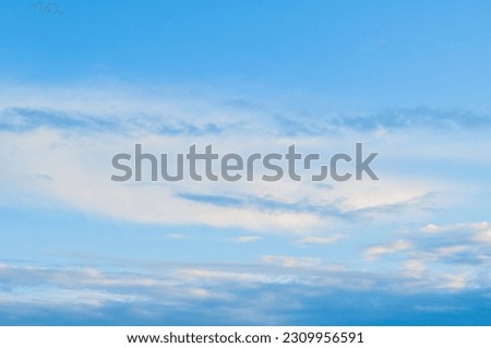 Blue sky sunrise landscape with pastel white clouds - picturesque vast sky view