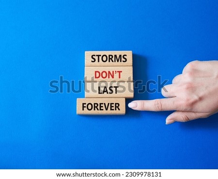Storms do not last forever symbol. Concept words Storms do not last forever on wooden blocks. Businessman hand. Beautiful blue background. Happiness concept. Copy space