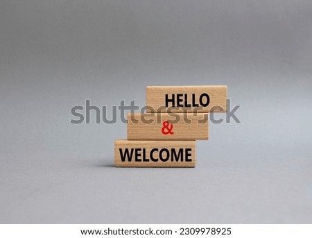 Hello and Welcome symbol. Concept words Hello and Welcome on wooden blocks. Beautiful grey background. Business and Hello and Welcome concept. Copy space.