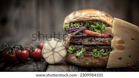 Burger on wooden board front view ingredients on rustic background