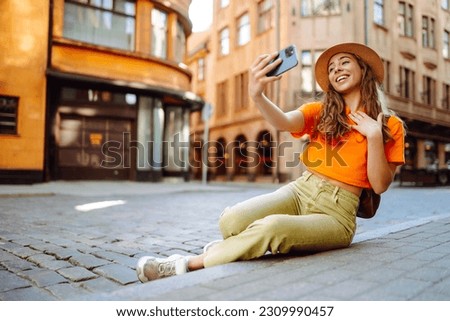 Selfie time. A tourist walks the streets and  takes selfie using smartphone camera.   Lifestyle, travel, tourism, active life.