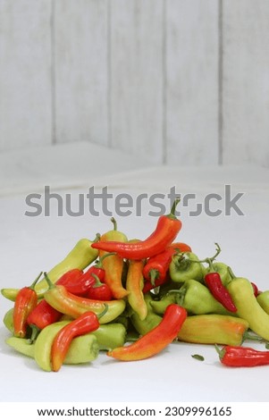 Pepper, chili, in bulk, white wooden table, fresh vegetables, photo background, vitamins, background