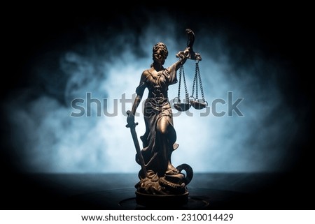 No law or dictatorship concept. The Statue of Justice with anti-riot police helmet holding scale. Creative artwork decoration with colorful toned foggy background. Selective focus
