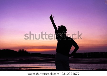 Silhouette's back view of a Strong woman mother with raised hands looking to sky. concept of goal, success , and life goals concept. A young woman successful life. Goal strong.confident woman.Hero.