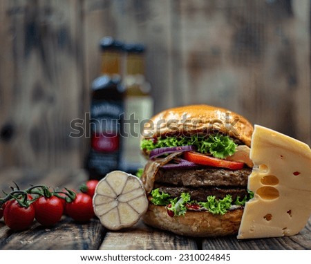 Burger on wooden board front view ingredients on rustic background