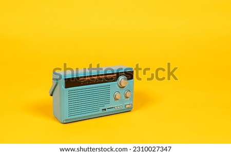 Side view of old radio receiver light blue color isolated on yellow background with copy space