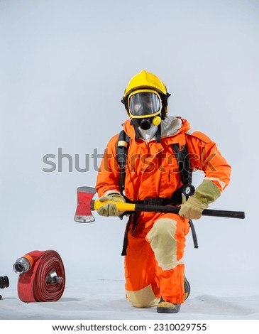 Vertical picture of kneeling position and the firm grip on the iron axe signifies the firefighter's commitment to being proactive and vigilant always prepared to confront potential hazards.