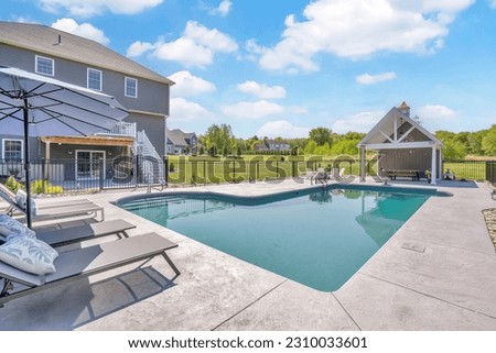 Luxury private backyard with a inground pool Royalty-Free Stock Photo #2310033601