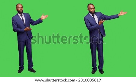Male entrepreneur creating advertisement on camera, talking about something on left or right sides. Professional company manager doing ad presentation over full body green screen.