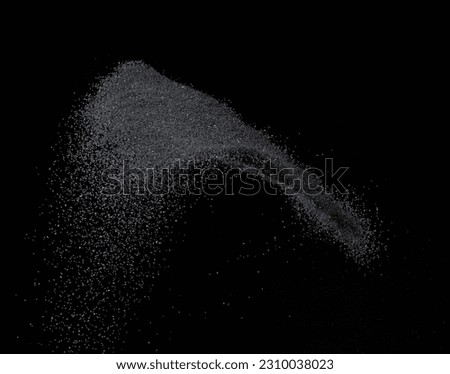 Million of black sand explosion, Photo image of falling down sands flying. Freeze shot on black background isolated overlay. Tiny Fine sand dust magnet as particle disintegrate science Royalty-Free Stock Photo #2310038023